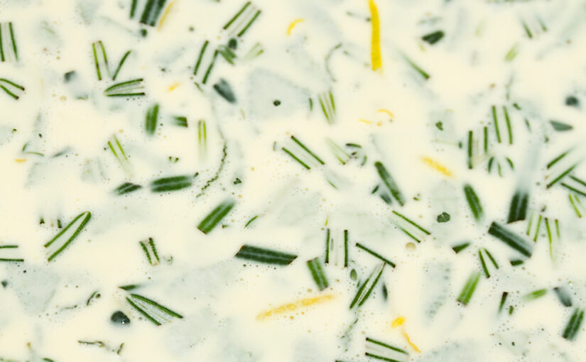 Making a quiche with rosemary and lemon zest.