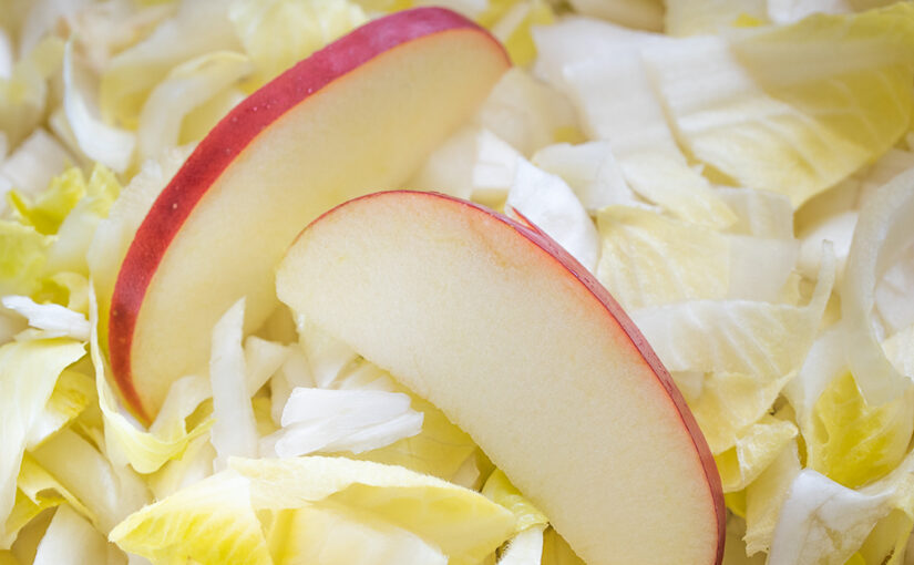 The making of a chicory-apple salad, served with baked potatoes and oven bag chicken