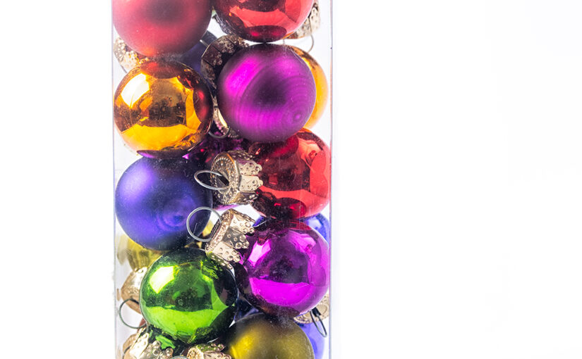 A plastic box with Christmas balls on a white background.